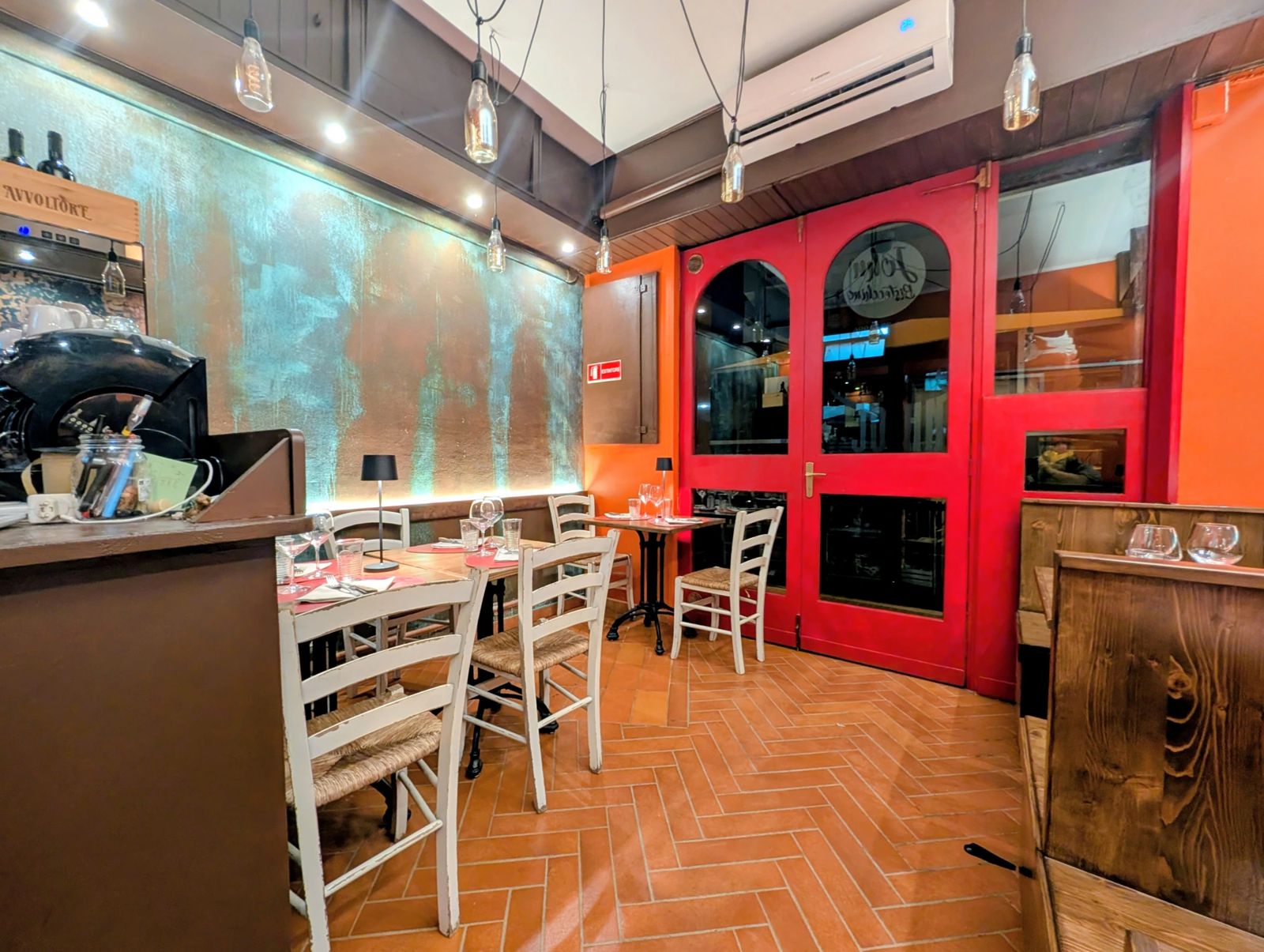 John Bistecchino's dining room: red doors, straw chairs and oxidised wall